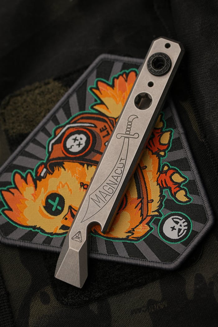 service-01 Sleek modern multitool resting on a colorful custom embroidered patch.